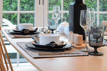 wooden table and chairs in dining room with elegant table settin