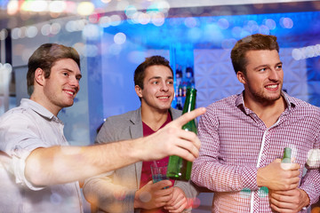 group of male friends with beer in nightclub