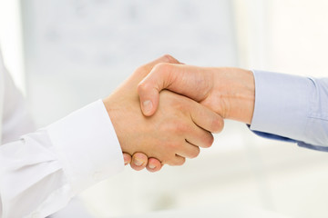 close up of hands making handshake in office