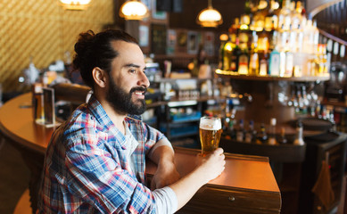 happy man drinking beer at bar or pub