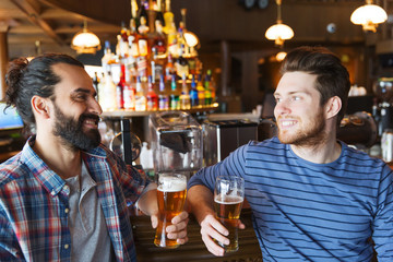 happy male friends drinking beer at bar or pub
