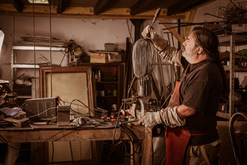 Fototapeta na wymiar Metal worker standing in workshop