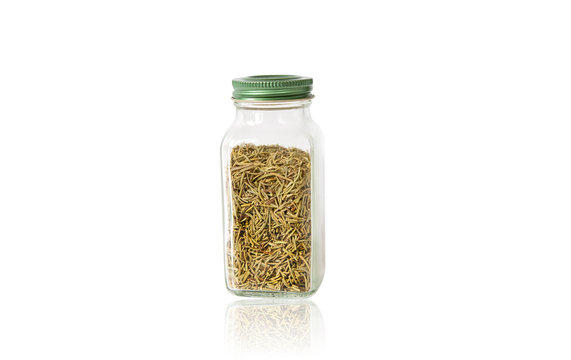 dried rosemary in glass jar isolated on white background with reflection
