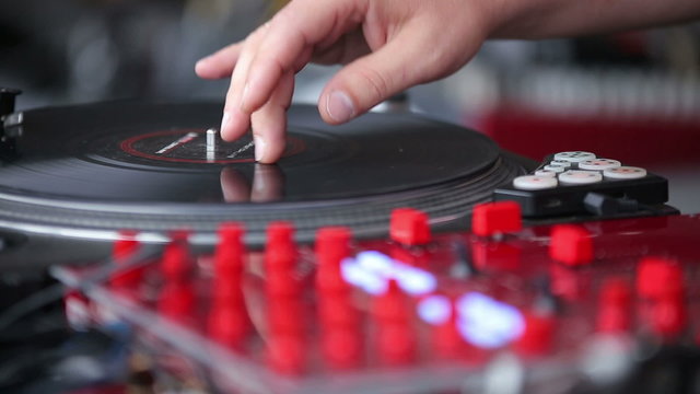 Hands of a Disc Jockey on the Professional Mixing Controller