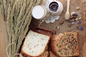 Brown bread with whole grain cereals of sliced and milk.