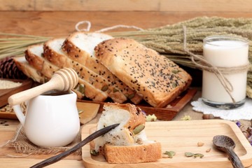 Brown bread with whole grain cereals of sliced and milk.