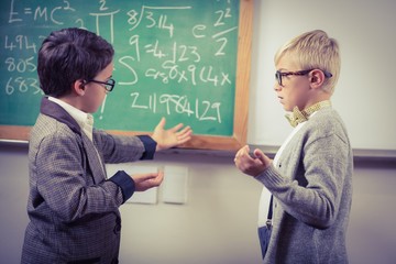 Pupils dressed up as teachers discussing in a classroom