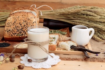 Brown bread with whole grain cereals of sliced and milk.