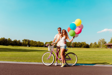 happy couple in love with the bike and balloons