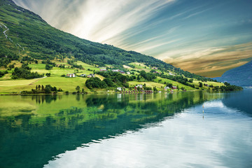 Norway, Olden, green hills seaside. Norwegian fjord in summer.