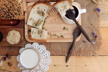 Brown bread with whole grain cereals of sliced and milk.