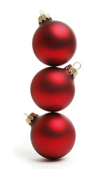 Three balanced Christmas Balls isolated on a white background.