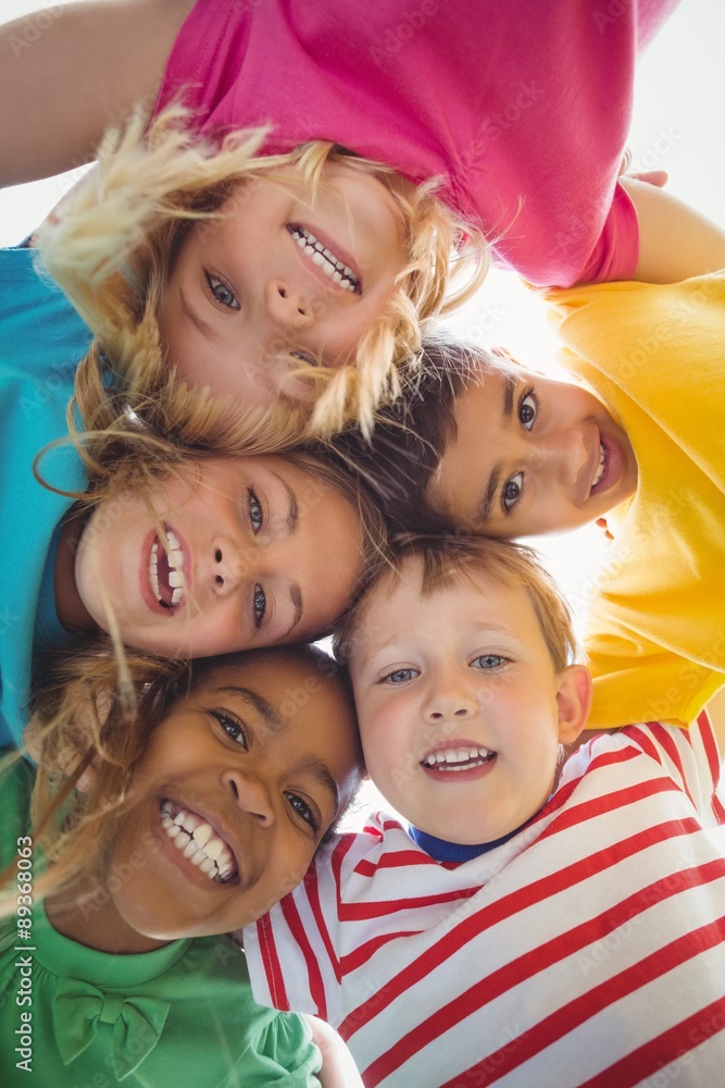 Wall mural smiling classmates with arms around looking down to camera