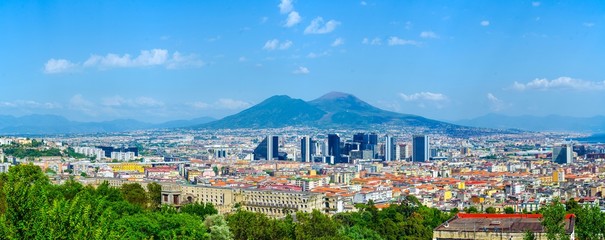 aerial view of centro direzionale business district in naples with mount vesuvius behind.