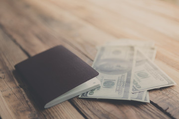 Blank passport with US dollars on wood table ( Filtered image pr