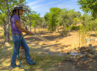 Mature woman with hat making work gardening