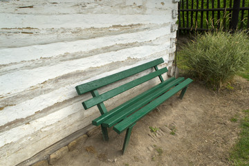 Green bank close to a  whitewashed wall of old village house