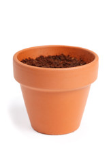 A clay flower pot with dirt. Isolated on a white background.