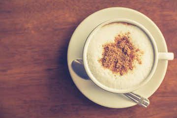Hot latte art coffee on table ( Filtered image processed vintage