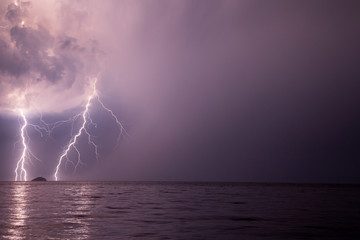 Spectacular lightnings on both sides of small island