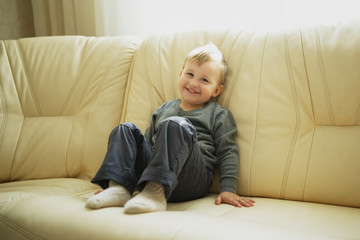 little boy sitting on couch