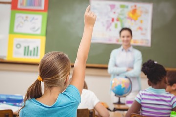 Pupil raising hand in classroom