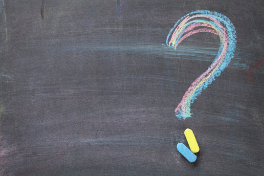 Colorful chalk question mark on blackboard background