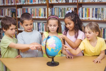 Pupils looking at the globe in library