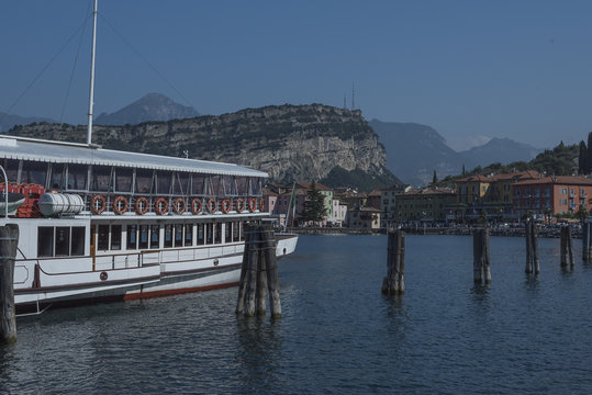 paddleboat on Lake Garda. Docking of Torbole. in the background the village in the foreground boat and wooden protection