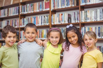 Pupils smiling at camera in library