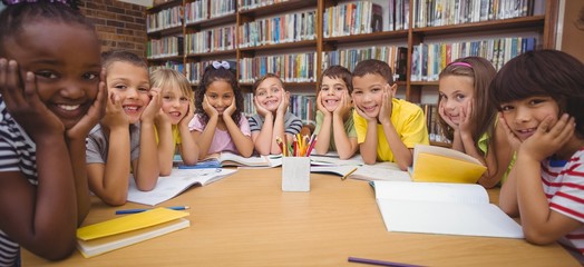 Pupils working together at desk in library