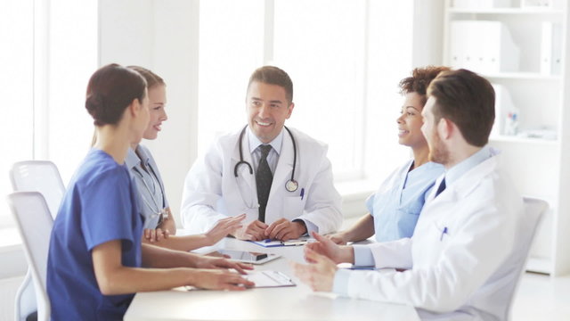 group of happy doctors meeting at hospital office