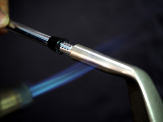 Naklejka premium Heat the Golf Head to break epoxy before remove shaft