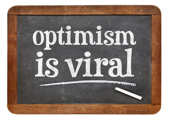 Fototapeta premium optimism is viral - text on blackboard