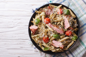 pasta with meat, parmesan, tomatoes and pesto. Horizontal top view
