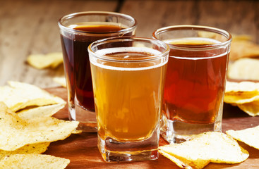 Three kinds of beer and potato chips, selective focus