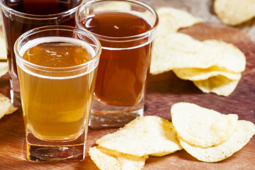 Three kinds of beer and potato chips, selective focus