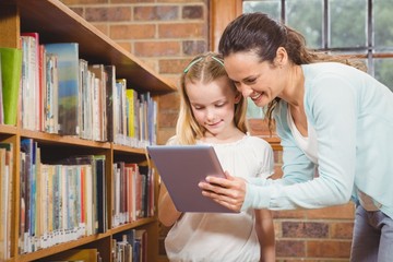 Teacher helping a student use a tablet