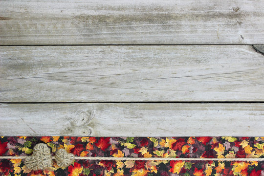 Blank rustic sign with autumn leaves and hearts border