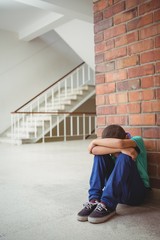 Upset lonely child sitting by himself