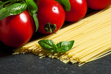Concept of italian food with pasta, tomato and basil, selective