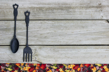 Blank rustic sign by cast iron spoon and fork and fall decor border