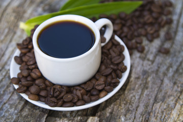 cup of coffee with leaf and beans