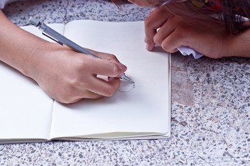 Children drawing on her note book.