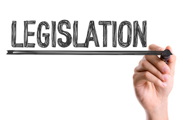 Hand with marker writing the word Legislation