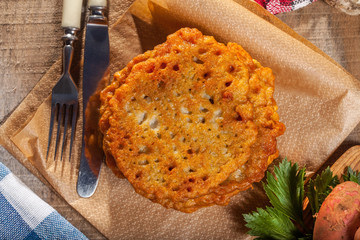 Potato pancake on a wooden table.
