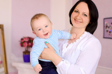 young mother holding cheerful baby son