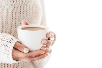 Warming cup of coffee in the hands of women isolated