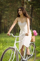 Happy young beautiful woman with retro bicycle