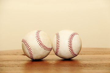 Objects: Two baseballs on a wood table